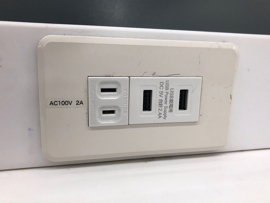 Japanese wall outlet marked AC100V with two Type A sockets and USB charging ports