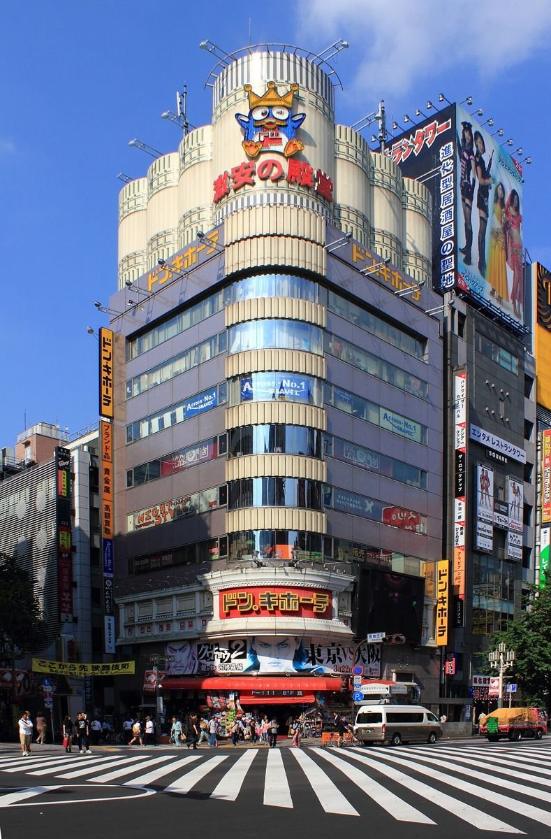 Tall Don Quijote discount store building in Shinjuku, Tokyo, with its penguin mascot sign on the roof