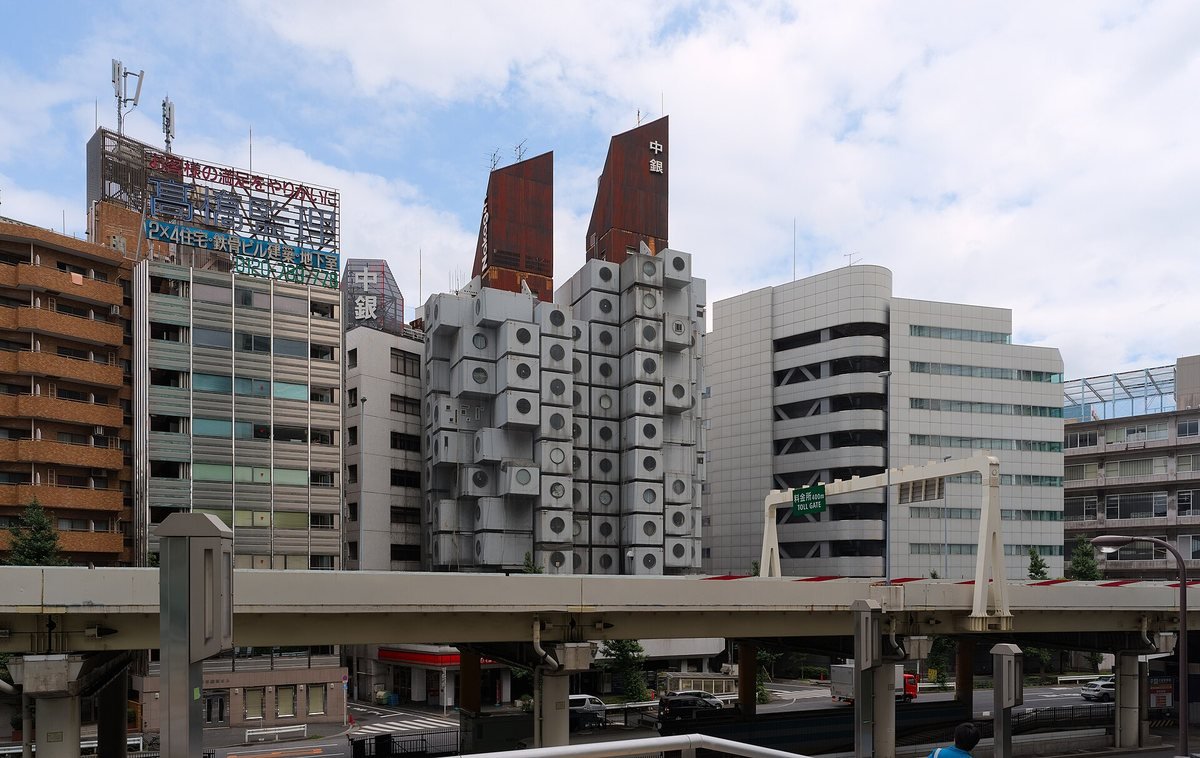 Kisho Kurokawa's Nakagin Capsule Tower in Ginza, Tokyo, with stacked grey capsules and round windows, in 2017