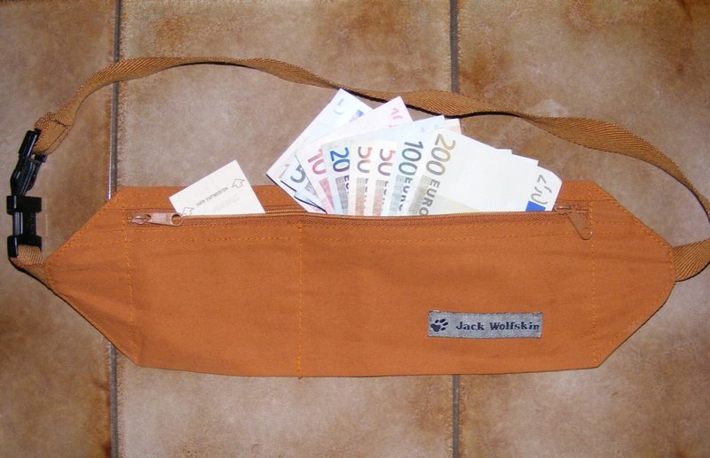 A tan money belt pouch with banknotes tucked inside (item type photo, not the exact product)
